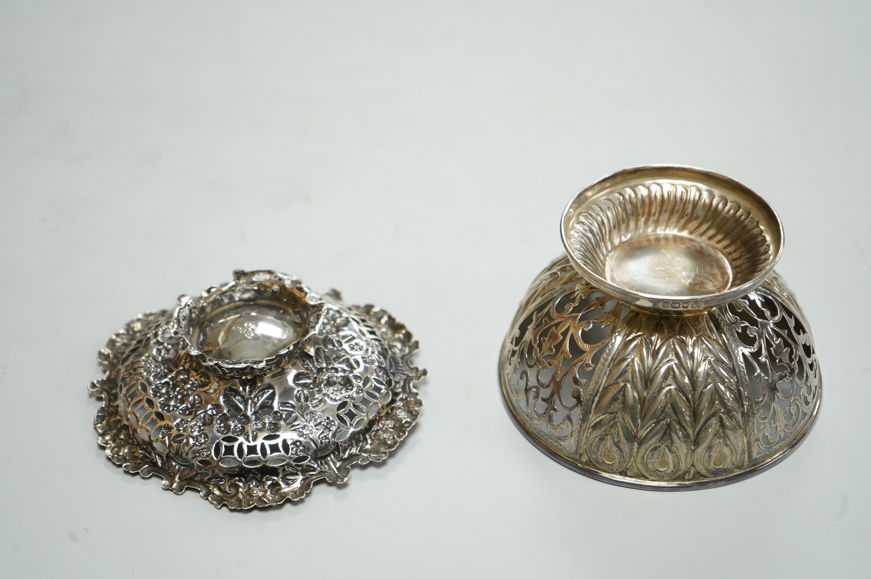 A late Victorian pierced repousse silver bonbon dish, on pierced foot, Nathan & Hayes, Birmingham, 1893, diameter 10.9cm, together with a modern silver bonbon bowl by C.J. Vander Ltd, 5.4oz.